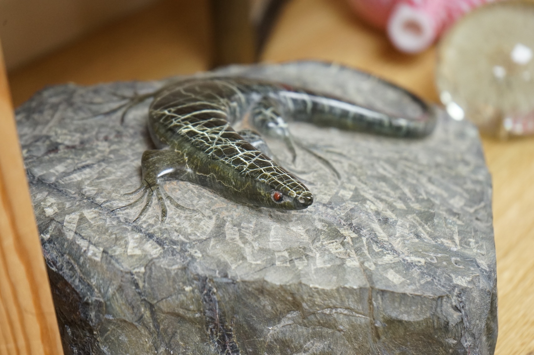 A carved green granite lizard, 27cm wide